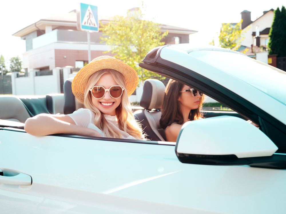 two beautiful women-enjoying summer days in a convertible.